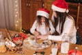 Making gingerbread at home. Little girl cutting cookies of gingerbread dough. Christmas and New Year traditions concept Royalty Free Stock Photo