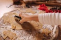 Making gingerbread at home. Little girl cutting cookies of gingerbread dough. Christmas and New Year traditions concept Royalty Free Stock Photo