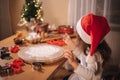 Making gingerbread at home. Little girl with her mom cutting cookies of gingerbread dough. Christmas and New Year Royalty Free Stock Photo