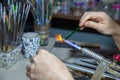 Making a glass bead on a gas burner Royalty Free Stock Photo