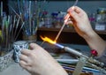 Making a glass bead on a gas burner Royalty Free Stock Photo