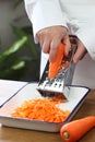 Making grated carrot salad, pouring olive oil