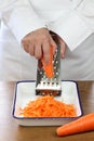 Making grated carrot salad, shredding carrots Royalty Free Stock Photo