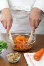 Making grated carrot salad, tossing a salad Royalty Free Stock Photo