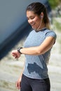 Making great progress. Shot of a young woman checking her watch while out exercising. Royalty Free Stock Photo