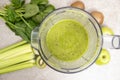 Making a green smoothie with celery, kiwi, apple and spinach in a blender, top view. Royalty Free Stock Photo