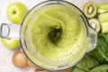 Making a green smoothie with celery, kiwi, apple and spinach in a blender, top view. Royalty Free Stock Photo