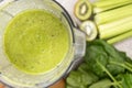 Making a green smoothie with celery, kiwi, apple and spinach in a blender, top view. Royalty Free Stock Photo