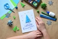 Making greeting card with origami 3D Xmas tree from paper. Merry Christmas and Happy New Year decoration. Childrens DIY concept. Royalty Free Stock Photo