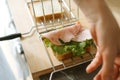 Making a ham and lettuce sandwich with slicer tool on wooden board Royalty Free Stock Photo