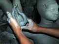 The making of hand of a clay idol of Hindu Goddess Durga.