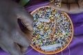 Making of handmade jewellery. Box with beads and african women hands, top view, close up. Island of Zanzibar, Tanzania, Africa Royalty Free Stock Photo