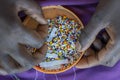 Making of handmade jewellery. Box with beads and african women hands, top view, close up. Island of Zanzibar, Tanzania, Africa Royalty Free Stock Photo