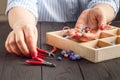 Making of handmade jewellery. Box with beads on old wooden table Royalty Free Stock Photo