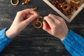 Making of handmade jewellery. Box with beads on old wooden table. Top view with woman hands Royalty Free Stock Photo