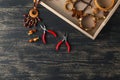 Making of handmade jewellery. Box with beads on old wooden table. Top view with woman hands Royalty Free Stock Photo