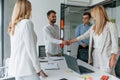 Making handshake. Group of professional business people is in the office Royalty Free Stock Photo