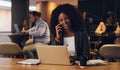 Making headway towards another great venture. a young businesswoman talking on a cellphone while working on a laptop in