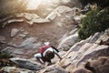 Making her way to the top. a young woman climbing a ladder while hiking in the mountains. Royalty Free Stock Photo