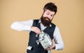 Making his savings in dollar. Businessman taking dollar cash out of glass jar. Bearded man hiding american dollar Royalty Free Stock Photo