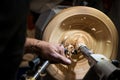 Making a hole into a wooden bowl on turnery machine