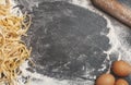 Making homemade background pasta. Kitchen table background with flour, pasta, rolling pin and eggs for making dough and Royalty Free Stock Photo