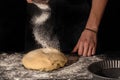 Making homemade bread. Step-by-step instruction. The cook shapes the dough. Wooden background