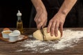 Making homemade bread. Step-by-step instruction. The cook shapes the dough. Wooden background.