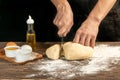 Making homemade bread. Step-by-step instruction. The cook shapes the dough. Wooden background.