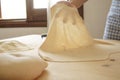 Making homemade fresh pasta: backlit woman hand show the transparency of the just rolled out fresh pasta, traditional Italian