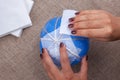 Making a homemade papier-mache pumpkin from a balloon and napkins, decor for the celebration of Halloween Royalty Free Stock Photo