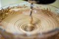 Making of ice cream by blending cocoa powder with cream. Blending the mixture by using blender rotating fast in circular. Used