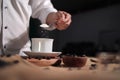 Bar keeper pouring coffee powder and sugar into a cup Royalty Free Stock Photo