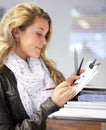 Making a list of what I need. a young female artist trying out various writing equipment in an art store. Royalty Free Stock Photo