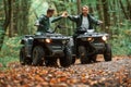 Making love gesture by hands. Beautiful couple. Two male atv riders is in the forest together Royalty Free Stock Photo