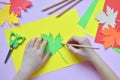 Making maple leaf from colored paper with your own hands for decoration of greeting card. Handmade crafts. Hello Autumn concept. C