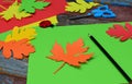 Making maple leaf from colored paper with your own hands for decoration of greeting card. Handmade crafts. Hello Autumn concept. C Royalty Free Stock Photo