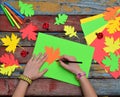 Making maple leaf from colored paper with your own hands for decoration of greeting card. Handmade crafts. Hello Autumn concept. C