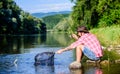 Making me happy. mature bearded man with fish on rod. successful fisherman in lake water. hipster fishing with spoon Royalty Free Stock Photo