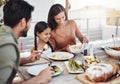 Making meal time, family time. a happy young family enjoying a meal together outdoors. Royalty Free Stock Photo