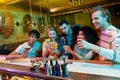 Making memories. Group of friends, young adults, men and women having fun while toasting, drinking cocktails at the bar Royalty Free Stock Photo