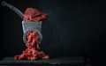 Making minced meat for beef meatballs in a manual meat grinder on a black background. Macro shot. Close up of metal meat grinder