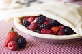 Making a Mixed Berry Pie: Covering the Berries with Uncooked Crust Royalty Free Stock Photo