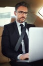 Making the most of his time. a businessman in the backseat of a car. Royalty Free Stock Photo