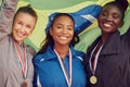 Making the most of our abilities. a group of female athletes holding a Brazilian flag.