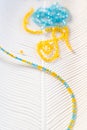 Making a necklace from yellow and blue beads Royalty Free Stock Photo