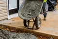 They are making a new concrete sidewalk path near the house with wet cement concreting with workers using the Royalty Free Stock Photo