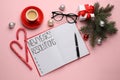 Making New Year`s resolutions. Flat lay composition with notebook and festive decor on pink background Royalty Free Stock Photo