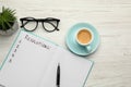 Making new year`s resolutions. Flat lay composition with notebook on white wooden table Royalty Free Stock Photo