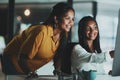 Making it one productive evening. two young businesswomen working together on a computer in an office at night. Royalty Free Stock Photo